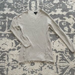 Tan sweater with sparkles.